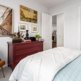 a bedroom with a bed and a chair