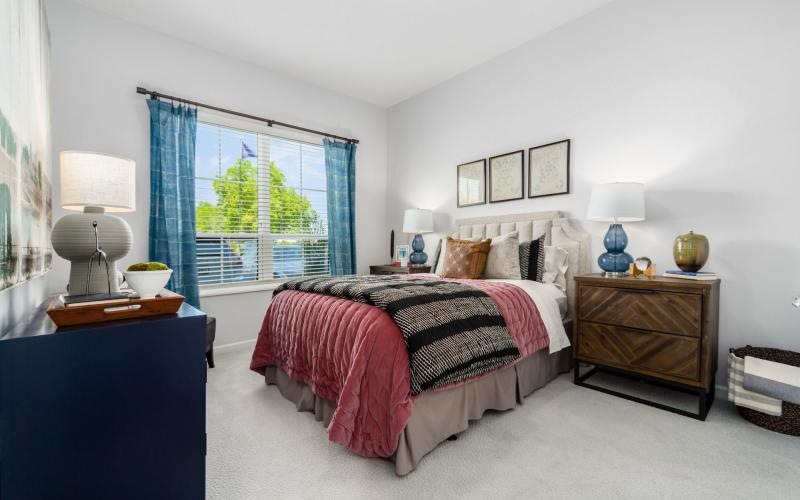 a bedroom with a bed and lamps